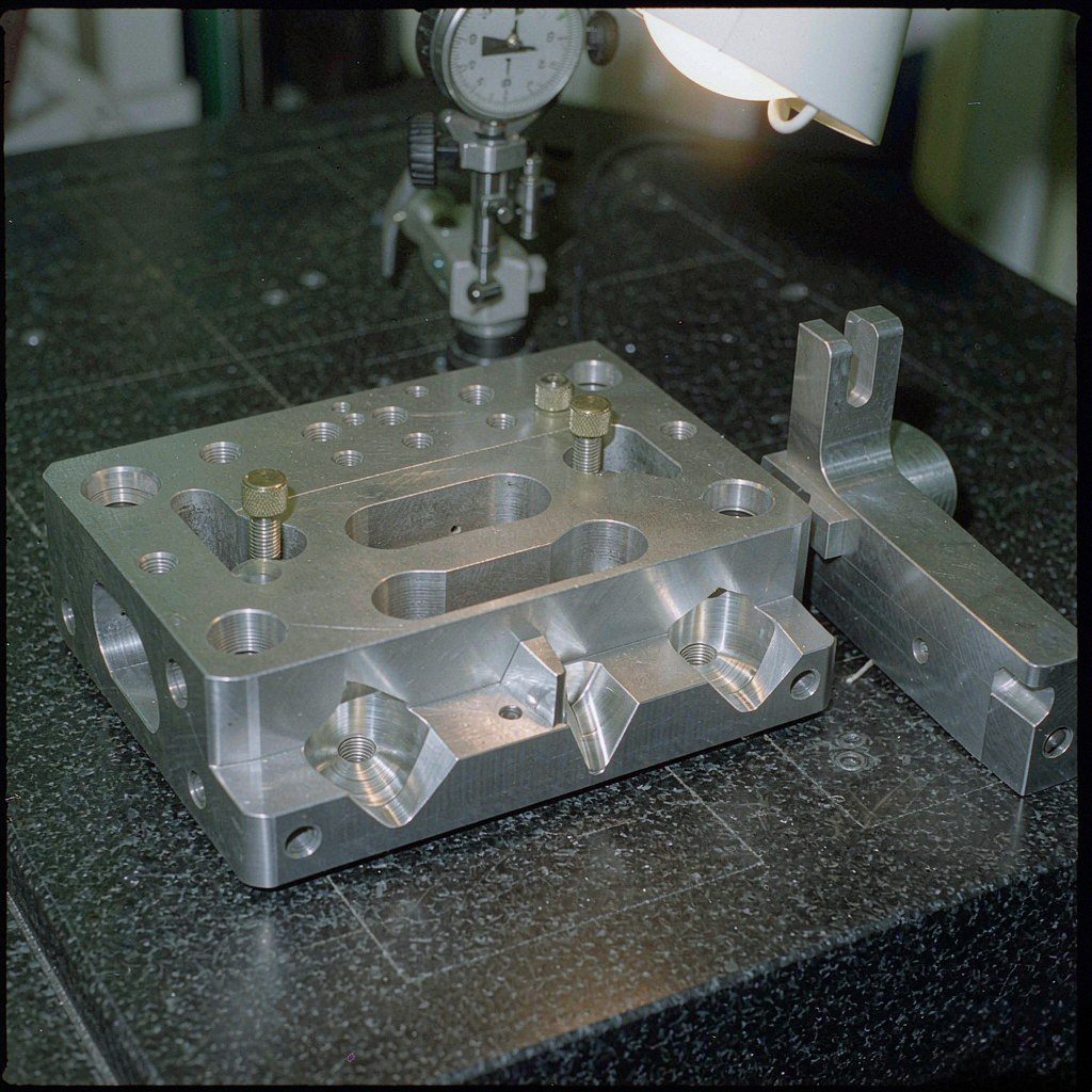 CNC machined alignment structure on a granite surface plate with kinematic seats, dowel holes and fine-pitch adjuster screws